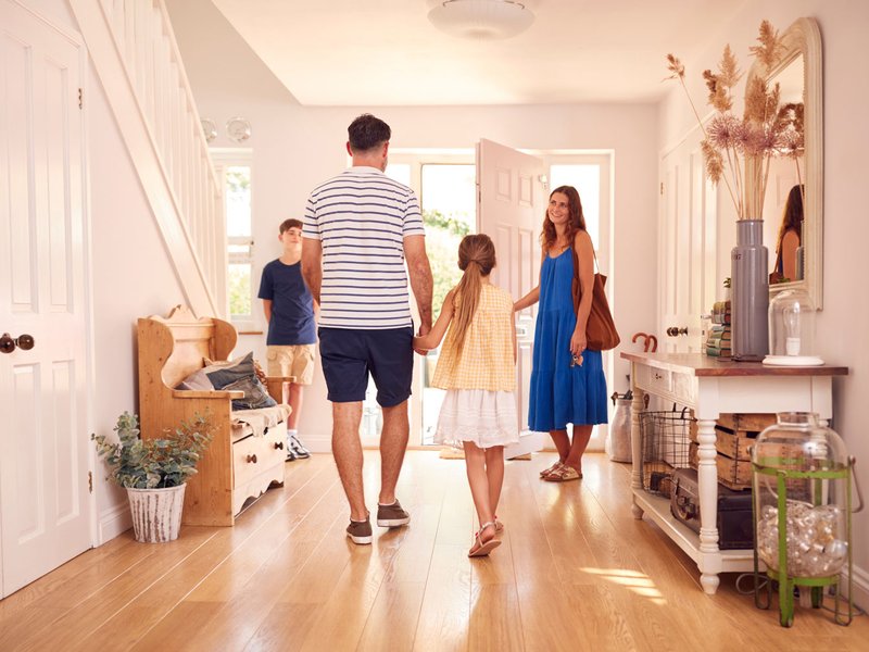 Family in etryway with hardwood floors